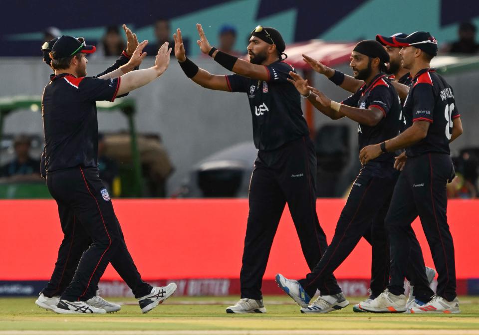 The US team celebrates catching Canada's Aaron Johnson during the 2024 ICC World Cup men's Twenty20 cricket match between the US and Canada at the Grand Prairie Cricket Stadium in Grand Prairie, Texas on June 1, 2024.